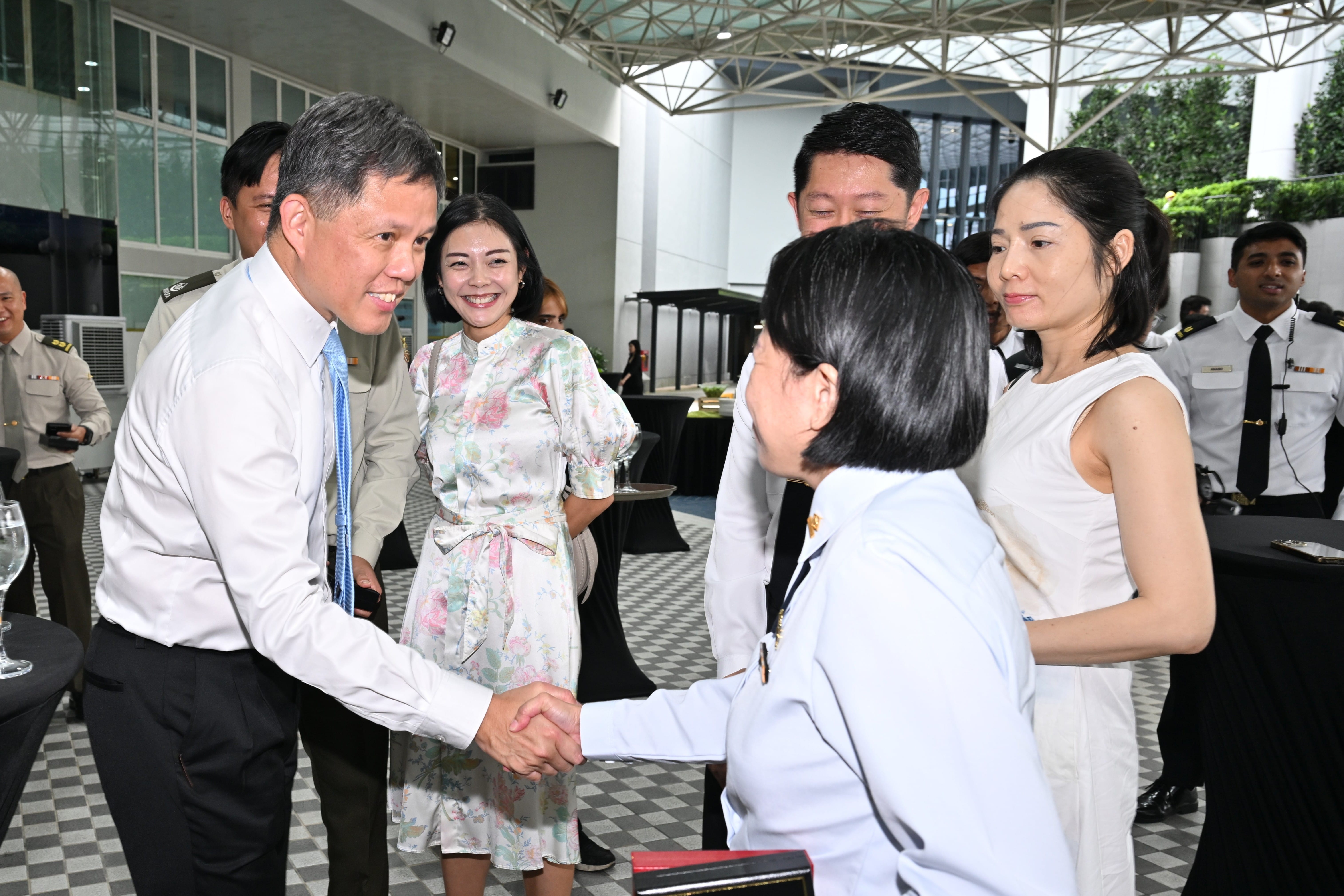 Minister for Defence Mr Chan Chun Sing interacting with award recipients and their partners after the investiture. 